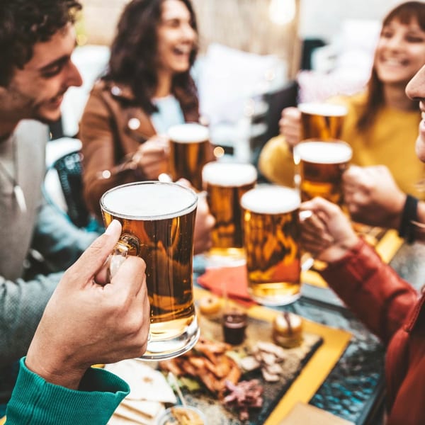Group cheering with beers over food