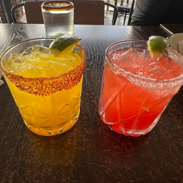 Two margaritas with chili and salt rims